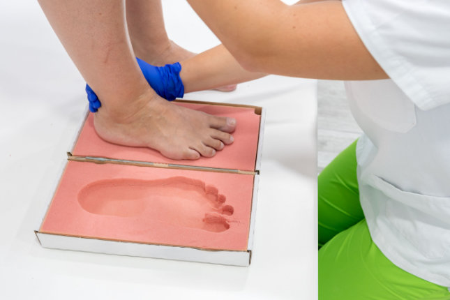 Feet standing over template mold