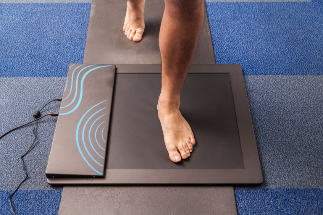 Feet standing over assesment device